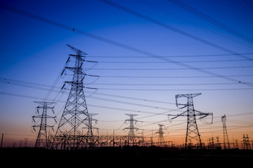 The silhouette of the evening electricity transmission pylon