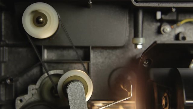 Inside a super 8mm film projector: macro detail shot of moving parts and components.
