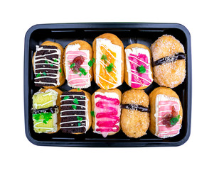 Colorful donuts in plastic box in sushi toppings style isolated