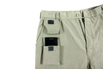 Green trouser front pocket opened with mobile phone inside