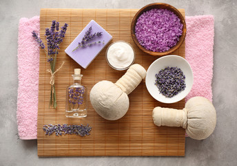 Spa composition with lavender, towel and salt on gray background