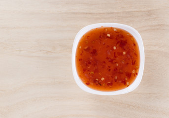 bowl of chili sauce on wood background
