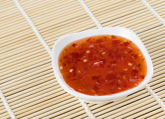 bowl of chili sauce on wood background