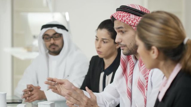  Arab business group in meeting, signing contract for a property deal