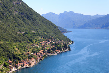 Fototapeta na wymiar Panorama of lakeside village Fiumelatte at Lake Como with mountains in Lombardy, Italy