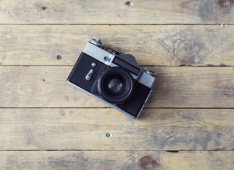 Vintage photo camera on a wooden background