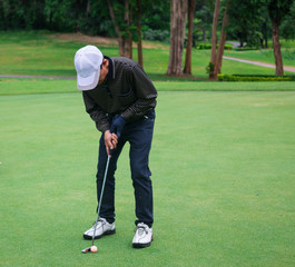 Male golf player in Golf court is Surrounded  natural
