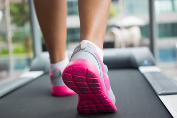Jogging on treadmill, focus on the treadmill, blurred motion
