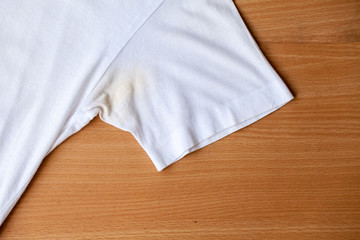 Shirts dirty caused by roll- on deodorant on wooden background