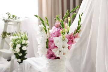 Beautiful decorated interior with bouquet of flowers in vase