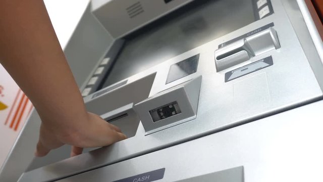 Woman withdraw cash from ATM