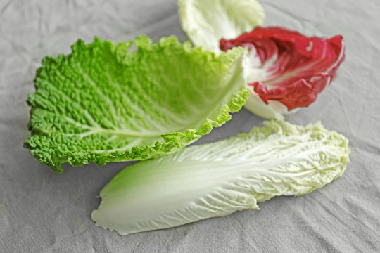 Various cabbage leaves on table