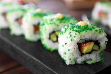 Delicious sushi set on wooden board