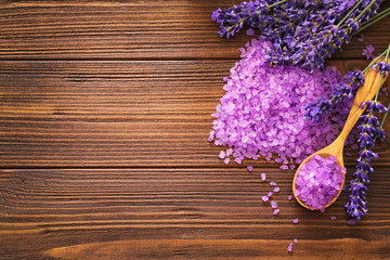Purple sea salt with lavender on wooden background