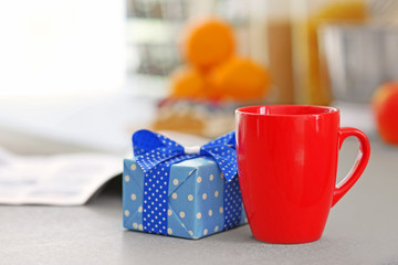Happy Fathers Day concept. Tea cup with presents on table