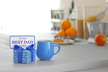 Happy Fathers Day concept. Tea cup with presents on table