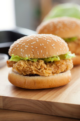 fried chicken burger on wooden board