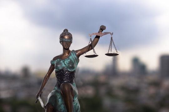 Lady Justice and city view