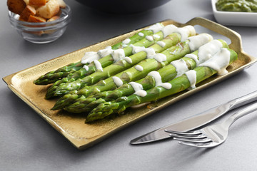 Asparagus with sauce on the tray