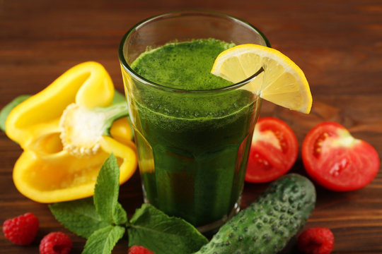 Tasty smoothie drink with vegetables and fruits on table