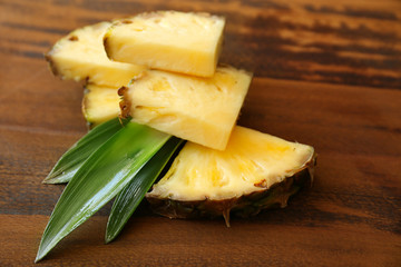 Pineapple slices on wooden background