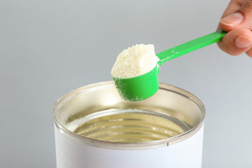 Preparing baby milk formula on light background