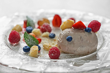 Ice cream with berries and mint leaves on plate