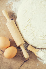 wooden rolling pin with freshly prepared dough