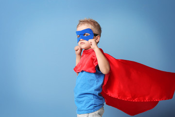 Superhero kid on blue background