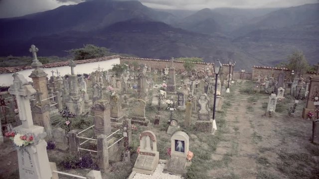 Top perspective of a cemetery with stone crosses on beautiful mountain landscape. Guane, Colombia