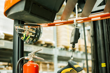 young man in working clothes, driver Reachtruck busy working on the logistics warehouse store