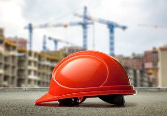 Red helmet on buildings and cranes