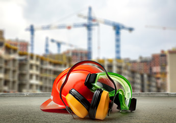 Red helmet and earphones on buildings background