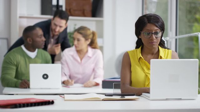  Cheerful teacher helping students in adult education class