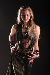 young girl in beads and bracelets on black background