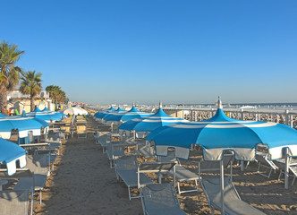 Obraz premium Umbrellas and gazebos on Italian sandy beaches. Adriatic coast. Pictures taken at sunrise 