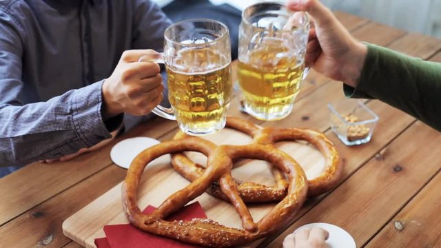 male friends drinking beer at bar or pub