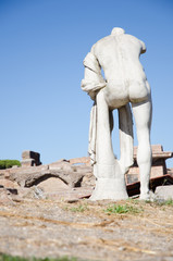 Fototapeta na wymiar Ruins of Ostia antica, Italy. Republican sacred area, statue of Hercules