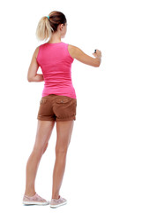 back view of writing beautiful woman. Rear view people collection.  backside view of person. Isolated over white background. Sport blond in brown shorts writes on his back.