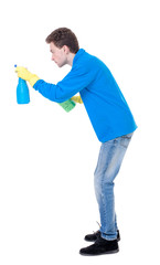 side view of a cleaner man in gloves with sponge and detergent. girl  watching.  view of person.  Isolated over white background. Curly boy in a warm blue sweater in the process of cleaning a side