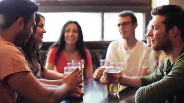 happy friends drinking beer at bar or pub