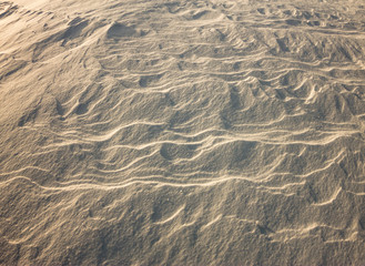 background snow waves at sunset by the wind