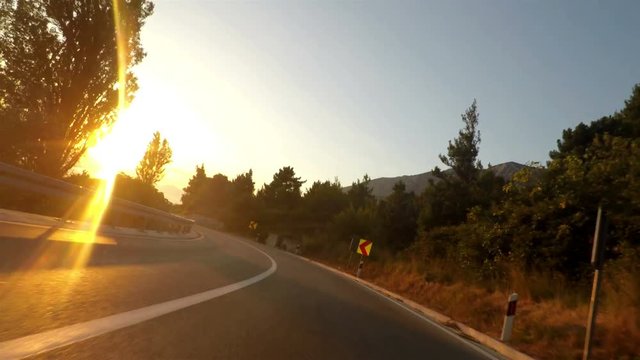 Driving motorcycle on the great road above the sea in Croatia point of view