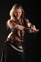 young girl in beads and bracelets on black background