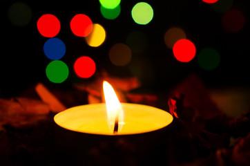 Christmas candle with colorful bokeh