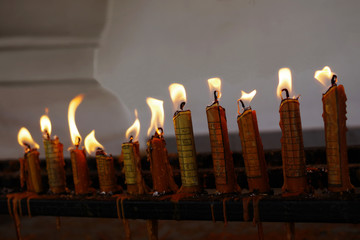 Candles with ancient magic letters burning to ward off bad luck