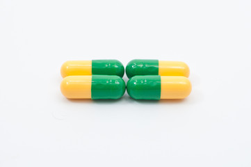 Pills and capsules on white background