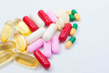 Pills and capsules on white background