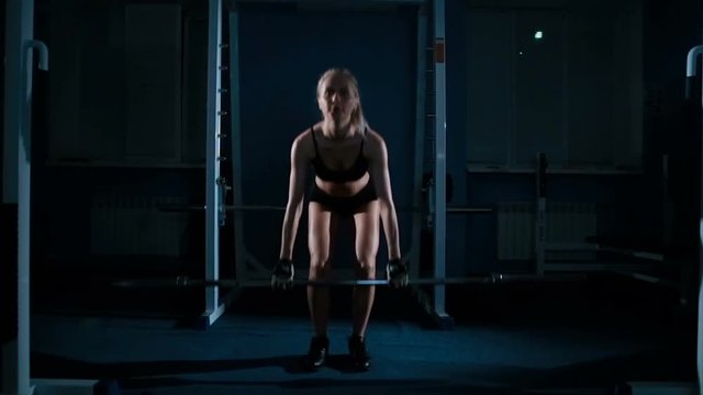 Young beautiful woman doing deadlifts Slow Motion