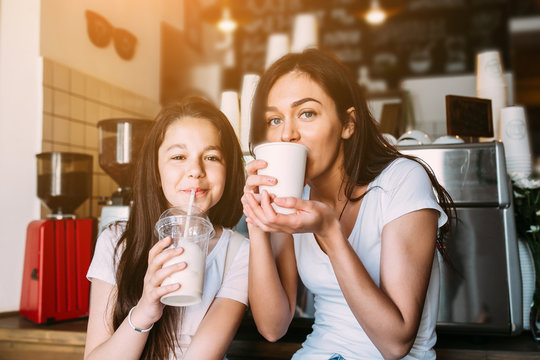 Mother and daughter drink espresso